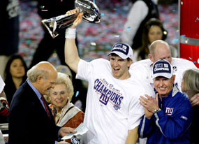 NY Giants QB Eli Manning holds 2008 Super Bowl trophy