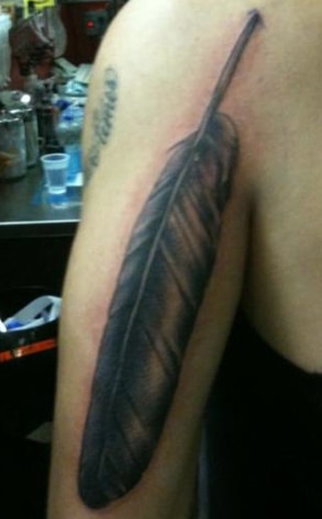  decorated with huge tattoos? Not only does the freshly inked feather 