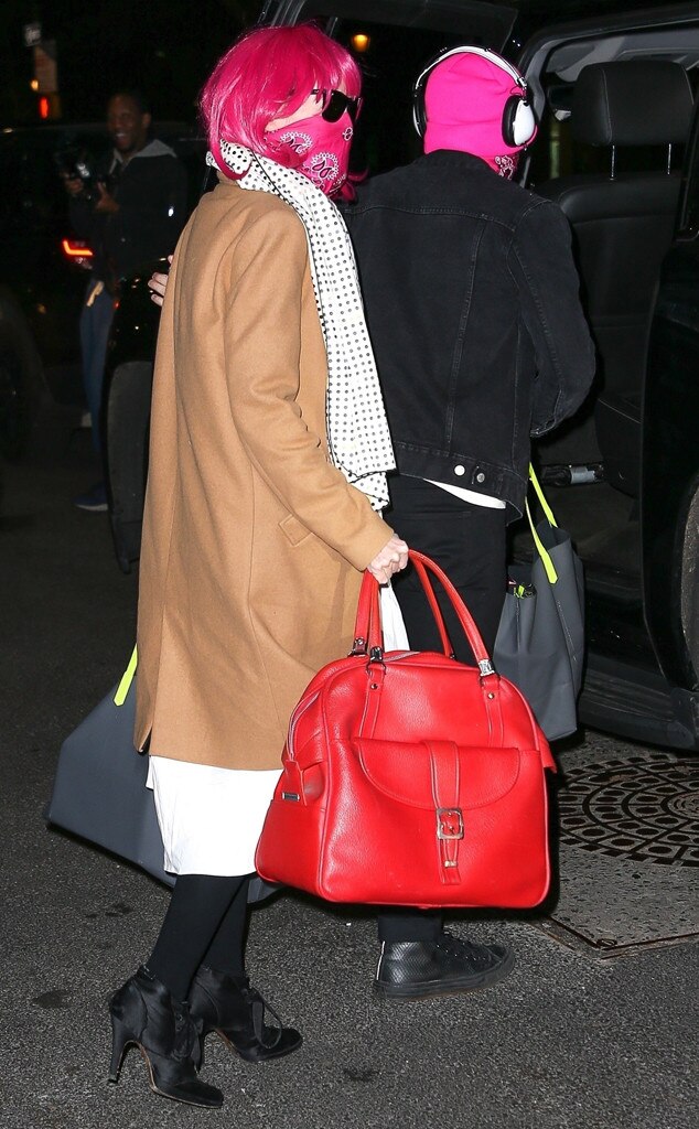 Lisa Hahnbueck wearing red Supreme x Louis Vuitton bag, khaki